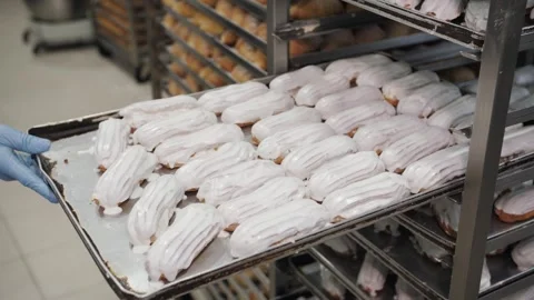 Freshly Iced Eclairs On Bakery Tray, Mass Production. Video stock 321822995