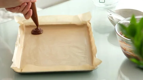 Freshly made chocolate chip cookies. Female hands place dough from a pastry bag Stock Footage 141844526