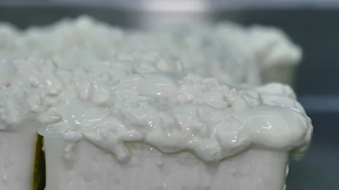 Freshly made cottage cheese inside the plastic mould Stock Footage 131374882