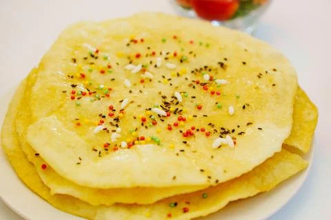 Freshly made flatbreads topped with colorful sprinkles and seeds Foto stock