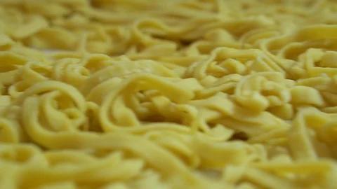 Freshly made pasta spread out on the kitchen table before cooking . semi-finishe Stock Footage 107077662