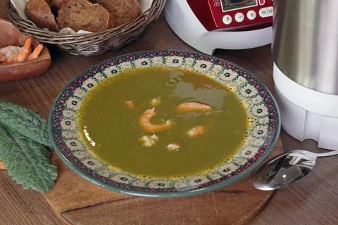 Freshly made vegetable soup puree cream soup kale with seafood in ceramic plate Stock Photos
