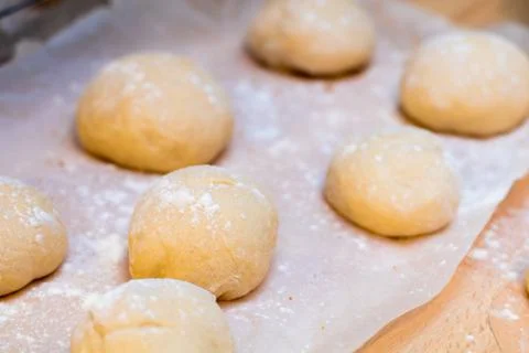 Freshly made white bread rolls proving Stock Photos