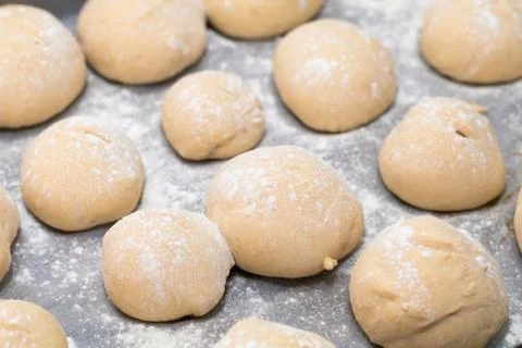 Freshly made white bread rolls proving Stock Photos