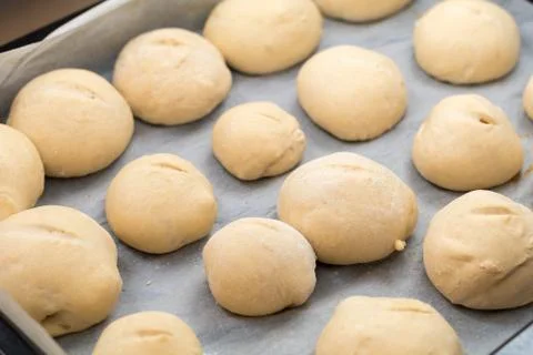 Freshly made white bread rolls proving Stock Photos