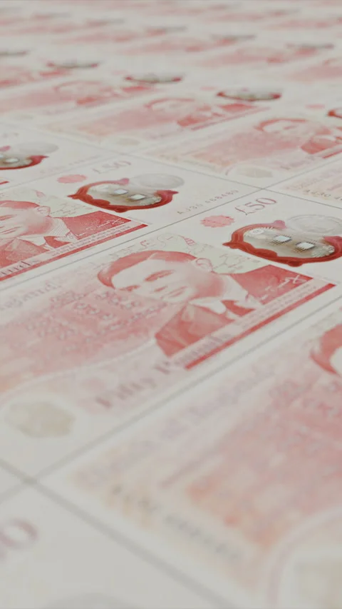 Freshly minted 50 pound sterling banknotes are cascading out of a money printer Stock Footage 310599151