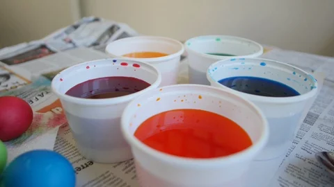 Freshly painted colorful Easter eggs on the table on the newspaper Stock Footage 128170518