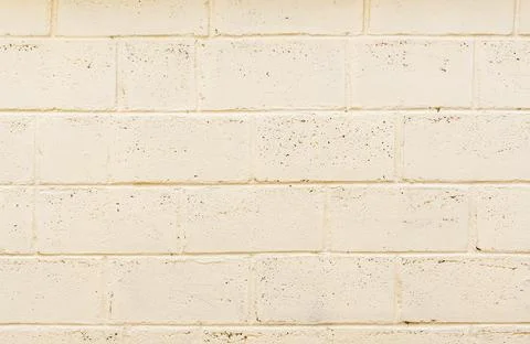 Freshly painted wall structure made of light beige foam concrete blocks, texture Stock Photos