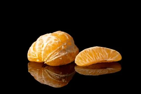 Freshly peeled orange on a solid black background 스톡 사진