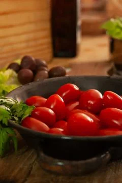 Freshly picked cherry tomatoes, in a rustic kitchen. Stock Photos