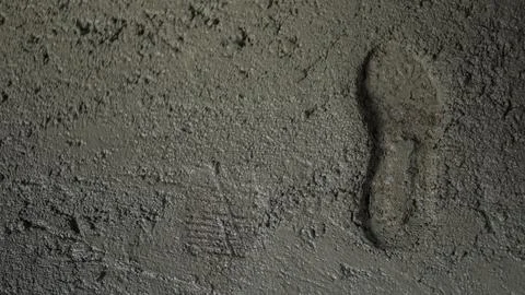 Freshly poured cement surface with a boot print. Stock Photos