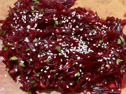 Freshly prepared beetroot salad featuring finely shredded beets, sprinkled with Stock Photos