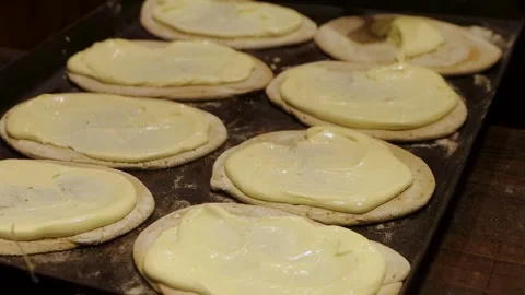 Freshly prepared flatbread dough pieces ready for toppings at a holiday str.. Stock-Footage 322704595