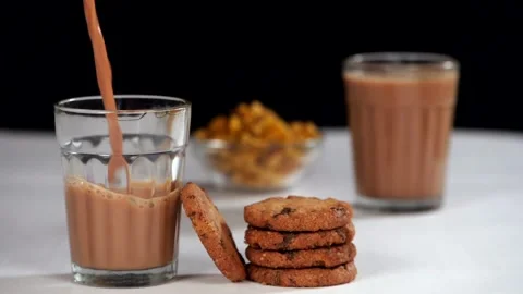 Freshly prepared hot tea served with crunchy and delicious biscuits for break... Stock Footage 157303673