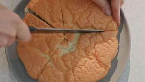 Freshly prepared orange sponge sliced skillfully with traditional tools. Handcut Stock Footage 334798120