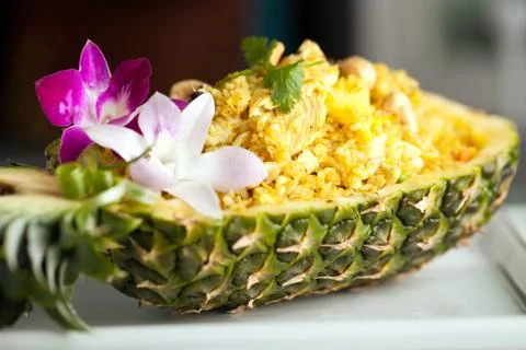 Freshly prepared pineapple fried rice served inside of a pineapple carved lik Stock Photos