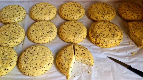 Freshly prepared solstice cheese with cumin seeds, one round sliced open on Stock Footage 313858483