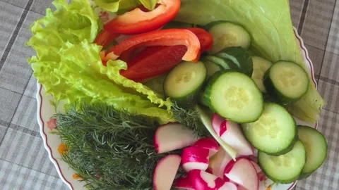 Freshly prepared vegetable platter featuring vibrant red bell peppe Stock Footage 336490746
