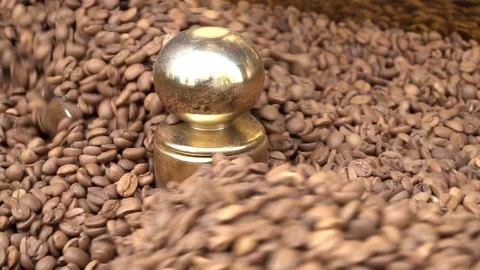 Freshly roasted aromatic coffee beans rotating slow motion in roasting machine Stock Footage 92938035