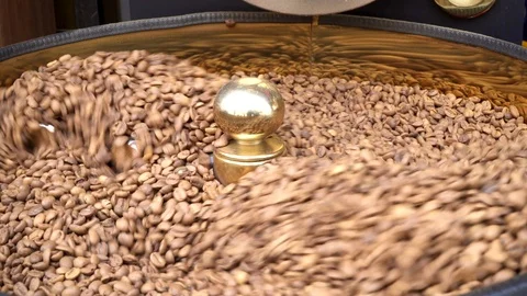 Freshly roasted aromatic coffee beans over a modern machine used for roasting  Stock Footage 92938273