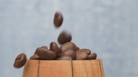 Freshly Roasted Coffee Bean Dropping Smoothly into a Beautifully Crafted Wooden 스톡 동영상 288970119