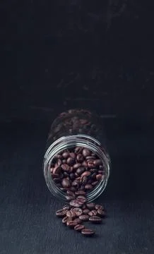 Freshly roasted coffee beans. A bundle of coffee beans on a dark background.. Stock Photos