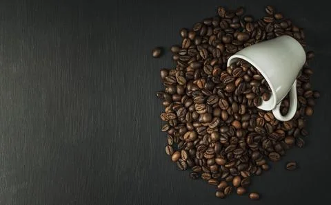 Freshly roasted coffee beans. A bundle of coffee beans on a dark background.. Stock Photos