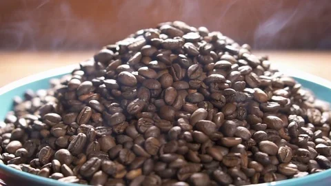 Freshly roasted coffee beans in ceramic plate, slow motion. Stock Footage 84036098