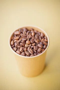 Freshly roasted coffee beans in a cup Stock Photos