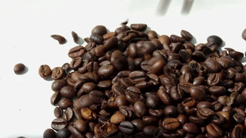 Freshly roasted coffee beans falling from pack,woman hands, on table Stock Footage 201523995