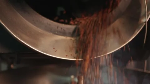 Freshly roasted coffee beans falling into the cooling tray Stock Footage 334732438