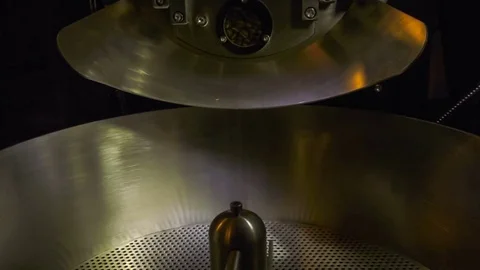 Freshly roasted coffee beans pouring into cooling tray Stock Footage 69785697