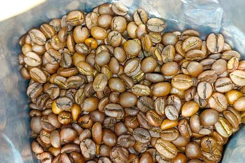 Freshly roasted coffee beans ready for brewing in a sealed bag for morning .. Stock Photos