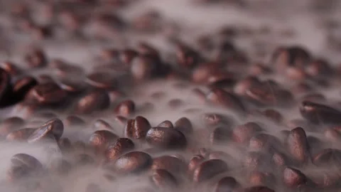 Freshly roasted coffee beans with a slow swirl of smoke. Stock Footage 186940559