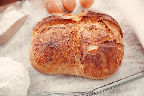 Freshly rustic loaf of bread isolated on wooden table background Stock Photos