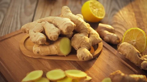 Freshly selected ginger root is carefully arranged on a rustic wooden plate Stock Footage 331353766