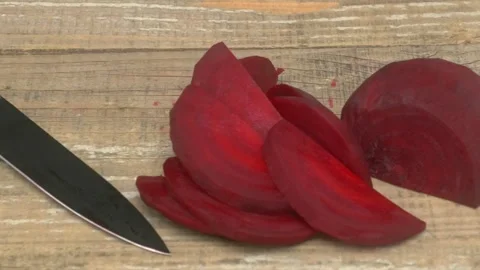 Freshly Sliced Beetroot Served with a Knife on a Rustic Wooden Surface for Видео 280693098