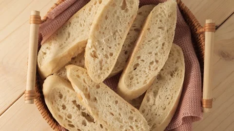 Freshly sliced bread rotating in a basket Stock Footage 344896373