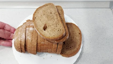 Freshly Sliced Brown Bread on White Plate- Rustic Kitchen Scene 스톡 동영상 317218123