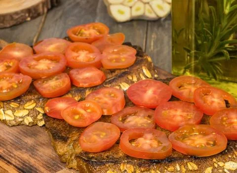 Freshly sliced cherry tomatoes on a rustic wooden surface Stock Photos