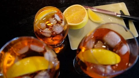 Freshly sliced orange in Aperol spritz drink in Slow motion Stock Footage