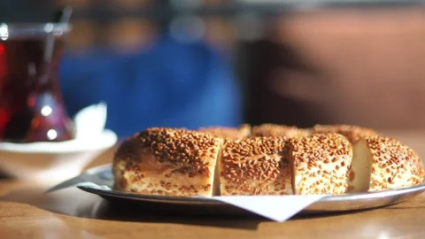 Freshly sliced turkish simit bread with sesame seeds on silver plate near h.. Stock Footage 332202371