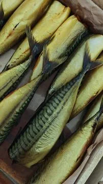 Freshly smoked mackerel fish arranged in a wooden box, showcasing their gol.. Stock Photos