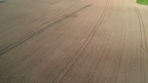 Freshly sowed  fields soil in spring with tractor tracks, aerial view Stock Footage 90089111