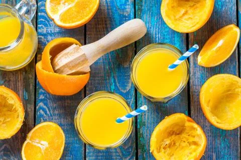 Freshly squeezed orange juice in a glass with straws Stock Photos