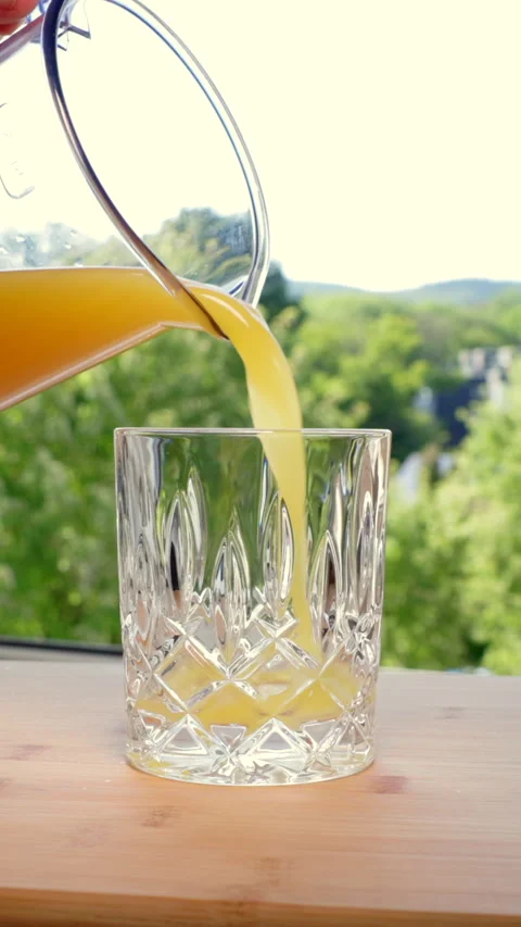 Freshly squeezed orange juice is poured into a glass; fruit contains fructose. Video stock 341345668