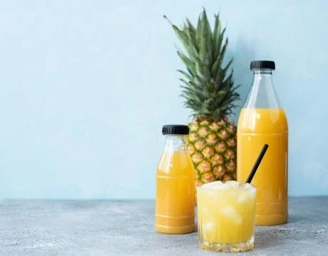 Freshly squeezed pineapple juice in plastic bottles Stock Photos