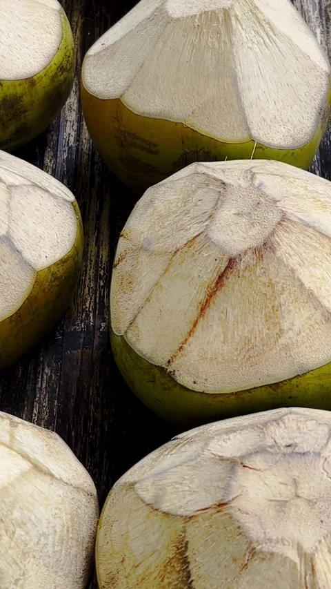 Freshly trimmed young coconuts prepared for tropical drinks Stock Footage 346741821