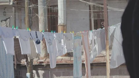 Freshly washed clothes hanging on a line 1 Stockbeeldmateriaal 329889718