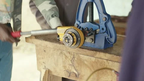 Frican Plumber making Threads on Steel Pipe Using Manual Tools Stock Footage 341574030